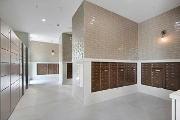 a large locker room with wooden lockers and a brick wall at The Enclave at Deer Moss Creek, Florida, 32578